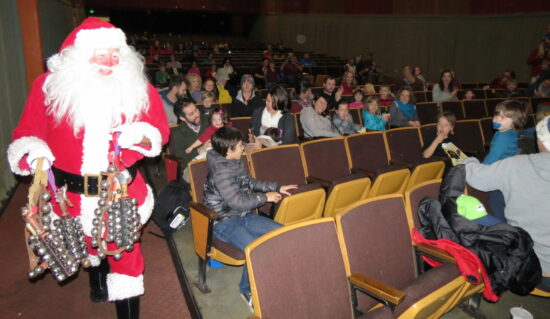 Santa Claus enters the Admiral Theater auditorium after the showing of two Christmas cartoon shorts.