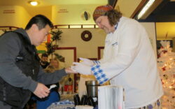 Chef "Wild" Bill Ranniger (right) of Duke's Chowder House serves free chowder to visitors.
