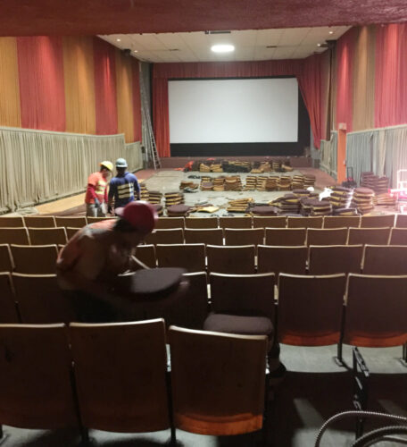 Workers remove seats on Sept. 21 in the eastern auditorium of the Admiral Theater.